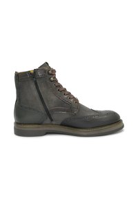 Stivale da ankle in pelle marrone con pannelli in suede, dettagli brogue, chiusura con lacci e zip laterale, punta rotonda e suola piatta in gomma.