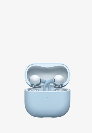 Wireless silver earbuds resting inside an open light blue charging case with a small green indicator light on the front.