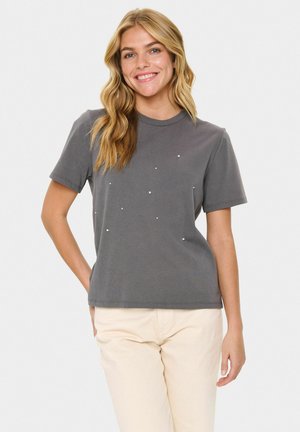 Graues Baumwoll-T-Shirt mit klassischem Rundhalsausschnitt, kurzen Ärmeln und verziert mit kleinen weißen Nieten in einem verstreuten Muster.