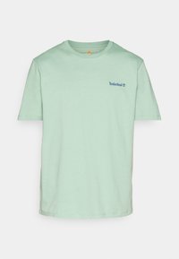 T-shirt Timberland vert menthe à manches courtes, col rond, avec un petit logo bleu sur la poitrine gauche.