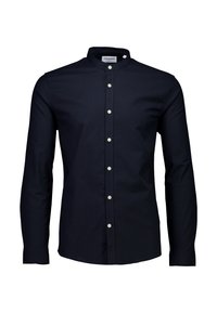 Laivastonsininen pitkähihainen paita, jossa pystypystykaulus, edessä valkoisilla napeilla varustettu napitus ja sileä, teksturoitu kangas.