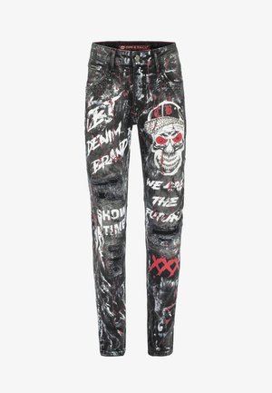 Black denim jeans featuring graffiti-style prints in white, red, and gray, with distressed areas and metal studs on the pockets.