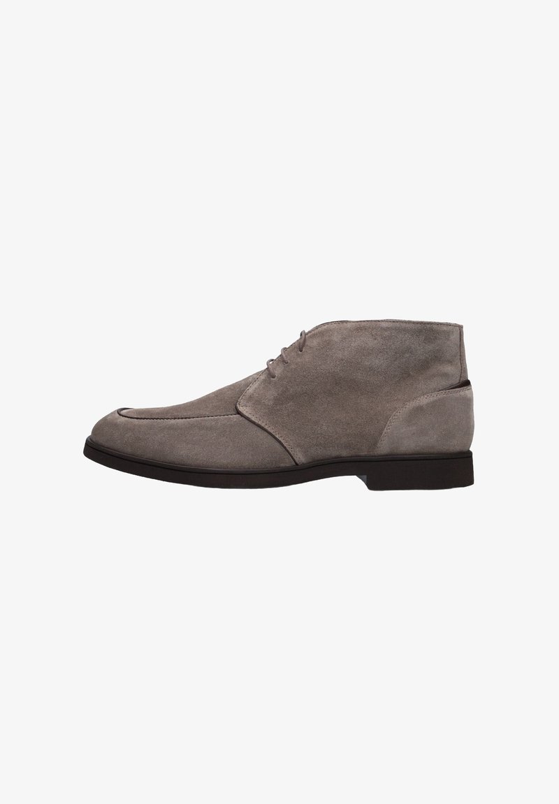 Bottes chelsea en suède gris avec un bout rond, un design à lacets et une semelle plate. Présente une texture lisse et des détails de couture minimalistes.