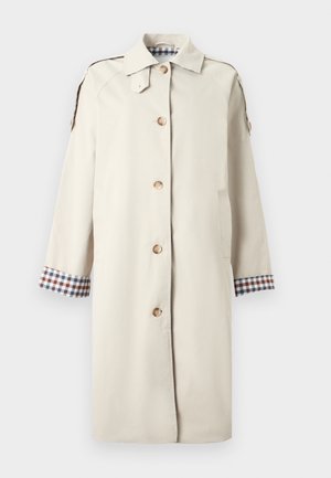 Beige trench coat with a button closure, two side pockets, and check-patterned cuffs. Made of smooth fabric with a structured, knee-length design.