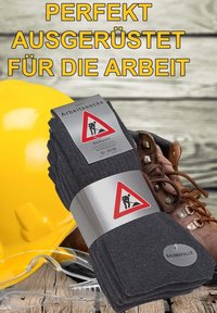 Calze da lavoro in cotone grigio con etichetta di avvertimento, accompagnate da un casco giallo, occhiali di sicurezza e stivali da lavoro marroni su una superficie in legno.