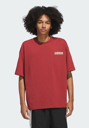 Rode katoenen T-shirt met een ontspannen pasvorm, korte mouwen en een ronde hals. Heeft een witte "adidas BASKETBALL" logo op de borst.
