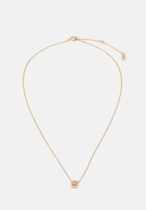 Necklace u zlatnoj boji sa delikatnim lancem, sadrži okrugli privjesak ukrašen kružnim rasporedom malih prozirnih kamenčića.