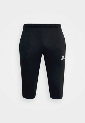 Black athletic shorts in a fitted design, made of smooth fabric, featuring an elastic waistband and a small white logo on the side.