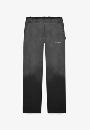 Mustat gradient sweatpants elastse paeltega, küljetaskute ja logo detailiga. Materjal näeb välja pehme ja siledast tekstuurist.