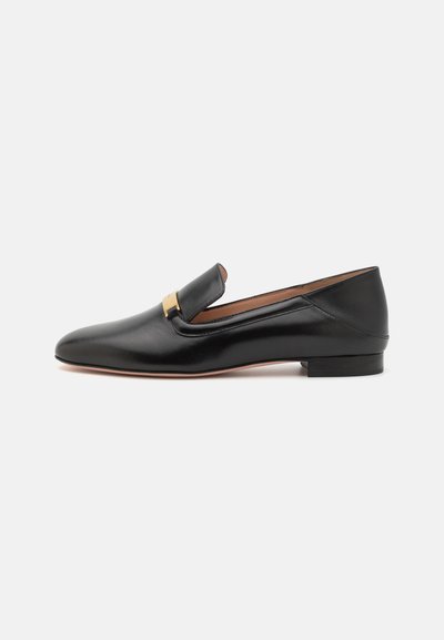 Black leather loafer with a sleek design, pointed toe, and a gold-tone hardware accent on the upper. Low heel and smooth texture.