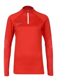 Maglietta atletica rossa a maniche lunghe con colletto a mezzo zip. Presenta maniche testurizzate con un motivo geometrico. Realizzata in materiale traspirante.