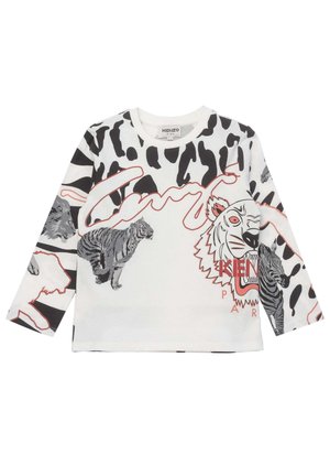 Hvid børneskjorte med lange ærmer med sort dyreprint, illustrationer af tiger, løve, zebra og rød omrids tekstdesign.