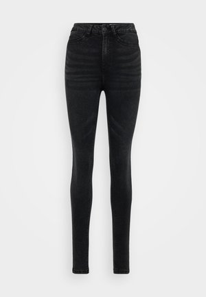 Svarte høyhalsede skinny jeans laget av denim. Har en klassisk fem lomme-design og subtil fading, med en glatt, myk tekstur.
