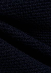 Dunkelblaues Strickgewebe mit einem strukturierten Muster, das dicke, sichtbare Stiche und ein weiches, dichtes Aussehen aufweist.