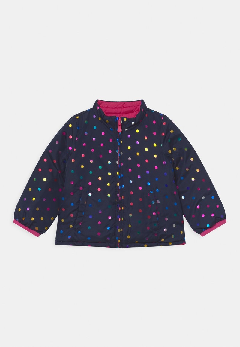 Navy puffer jacket with multicolored polka dots, a pink lining, zip closure, and two side pockets. Features elastic cuffs.