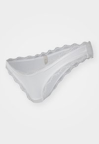 White lace-trimmed thong with a soft fabric texture, featuring scalloped edges and a standard low-rise design.