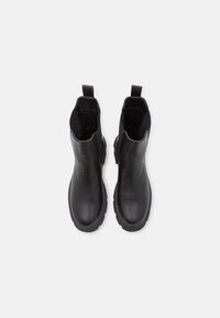 Black leather ankle boots with a smooth texture, round toe, elastic side panels, and pull tabs at the back. Thick black rubber sole.