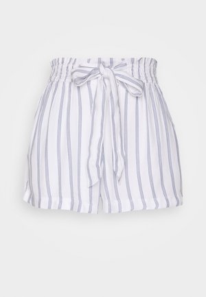Bílé šortky s modrými vertikálními pruhy, elastickým pasem a s detailem vázání vpředu. Měkká tkanina a uvolněný střih.