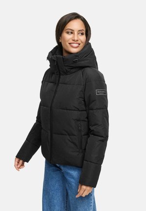 Black puffer jacket with a high collar, zippered pockets, and a logo patch on the left arm. Features a quilted texture and elastic cuffs.