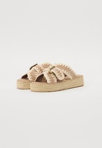 Sandales espadrilles avec une tige en tissu marron, semelle en jute tressé et broderie crème décorative le long des brides. Accent avec matériel ajustable.