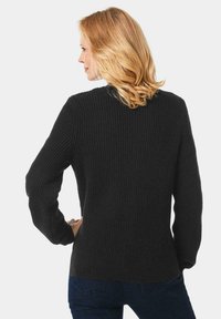 Schwarzer gerippter Pullover mit langen Ärmeln, strukturiertem Finish und gerundetem Halsausschnitt. Die Rückansicht zeigt einen taillierten Saum und eine lässige Silhouette.