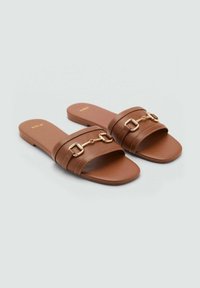 Brown slide sandals with two wide straps, gold chain accents, textured material, and a flat sole. Minimalist design with stitched details.