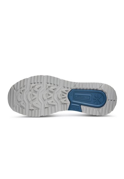 Gray rubber shoe sole with a textured pattern and blue accent section labeled "All-Terrain Grip." Features deep grooves for traction.