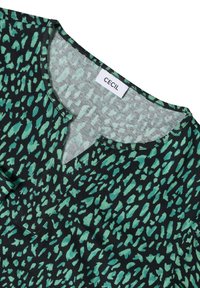 Haut noir avec un motif abstrait vert, présentant un décolleté en V et des manches courtes. Fabriqué en tissu doux avec une étiquette portant la mention "CECiL."