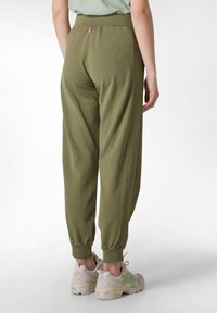 Olivengroene joggingbroeken met een hoge tailleband, elastische boorden en een klein roze labels aan de achterkant. Gemaakt van zachte, lichte stof.