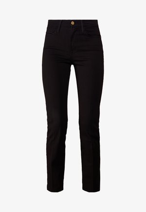 Svart denim jeans med smal passform, fem lommer og knapp i front. Stoffet har en jevn tekstur og en svak stretch.