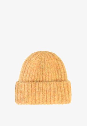 Adīta vāciņa gaiši oranžā krāsā, ar ribotu tekstūru un salocītu malu. Mīksts materiāls, noapaļots augšdaļā un viendabīga krāsa visā virsmā.