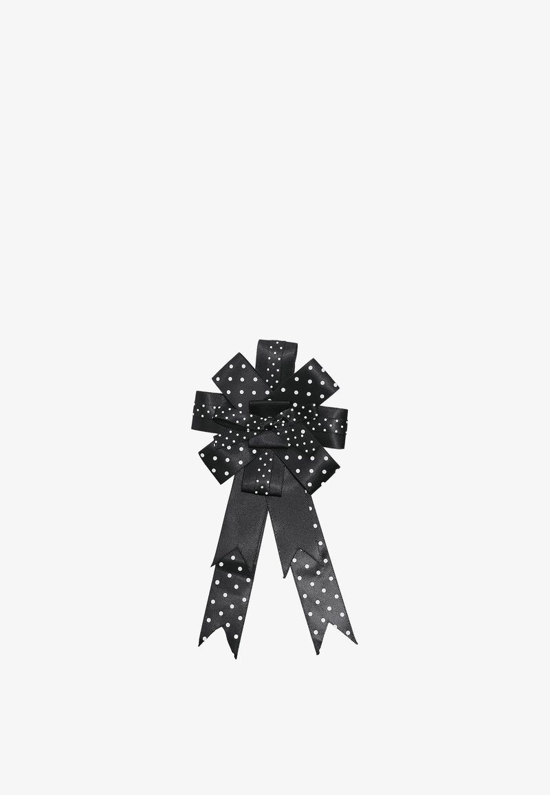 Nœud en ruban satin noir à pois blancs présentant plusieurs boucles et deux longues queues aux extrémités coudées.