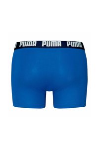 Boxer shorts blu in cotone morbido, con una vita blu navy e il logo "PUMA" bianco ripetuto attorno alla parte superiore.