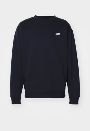 Navy blue sweatshirt made of soft fabric with crew neck, ribbed cuffs, and small white "N" logo on the chest. Simple, classic design.