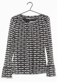 Blouse à manches longues en tissu noir transparent avec motif de chats blancs, dotée d'un ourlet à volants et d'un col froncé.