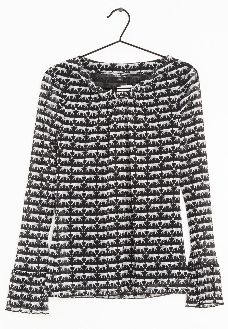 Blouse à manches longues en tissu noir transparent avec motif de chats blancs, dotée d'un ourlet à volants et d'un col froncé.