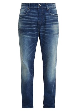 Jeans in denim blu scuro con leggeri segni di usura, design a cinque tasche, chiusura con zip e bottone in metallo. Tessuto morbido con taglio classico.