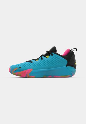 Blue athletic shoe with textured upper, black accents, and vibrant multicolored sole. Features a streamlined design and a pull tab at the heel.