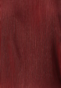 Tela texturizada con pliegues verticales estrechos. Color óxido profundo con un suave brillo, que proporciona un efecto visual suave.