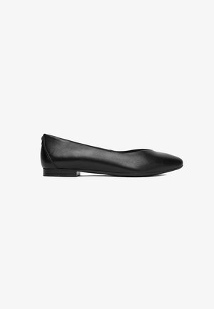 Black leather flat shoe with rounded toe and low heel, side view on white background.