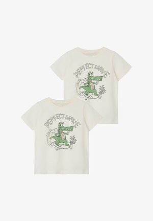 Organic cotton t-shirts in cream with a green crocodile graphic surfing, text "PERFECT WAVE," round neck, short sleeves, and relaxed fit.
