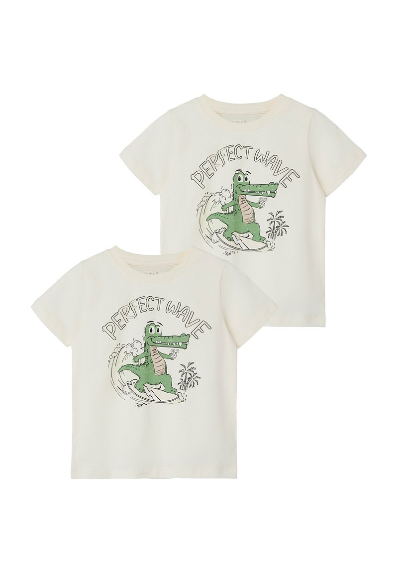 Organic cotton t-shirts in cream with a green crocodile graphic surfing, text "PERFECT WAVE," round neck, short sleeves, and relaxed fit.