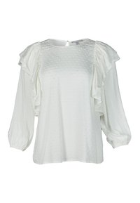 Valkoinen pusero, jossa on teksturoitu pilkkukuosi, röyhelösateet, pyöreä kaula-aukko ja avainaukkotakaosa. Valmistettu kevyestä kankaasta.