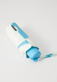 Blue and white patterned fabric umbrella cover with a light blue handle, featuring a wrist strap and left side tag.