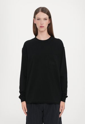 Black long-sleeve t-shirt with a round neckline, featuring a chest pocket and subtle texture details. Soft fabric with relaxed fit.