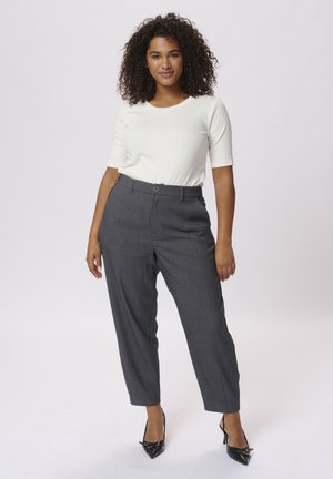 White short-sleeve top paired with high-waisted gray tailored trousers. Trousers feature a smooth texture and subtle check pattern. Black high heels.