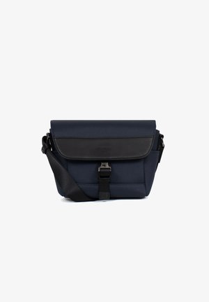 Compact navy blue crossbody bag with black flap, adjustable strap, and front buckle closure on white background.