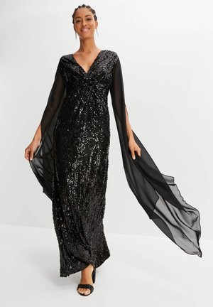 Abito da sera nero con paillettes, dotato di scollatura a V e maniche lunghe trasparenti, caratterizzato da una silhouette aderente e un design fluido.
