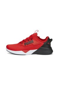 Red athletic shoe made of mesh and synthetic materials, featuring a black heel accent, contrasting white midsole, and prominent logo detail.