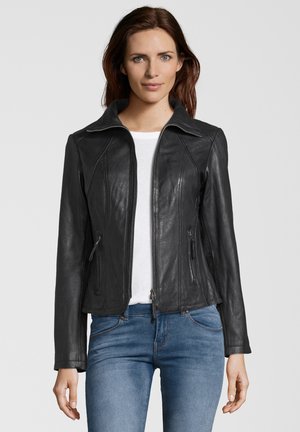 Black leather jacket with a zip front, collar, and side zip pockets. Features a fitted design and smooth texture, worn over a white shirt.
